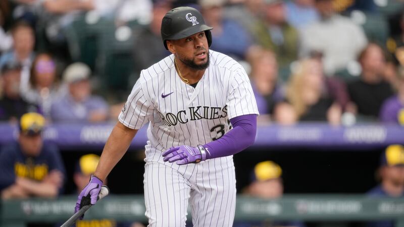 Colorado Rockies' Elias Diaz follows the flight of his RBI-sacrifice fly off Milwaukee Brewers...