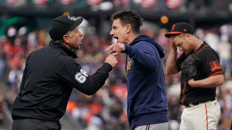 Milwaukee Brewers manager Craig Counsell, middle, gestures after being ejected by umpire Chris...