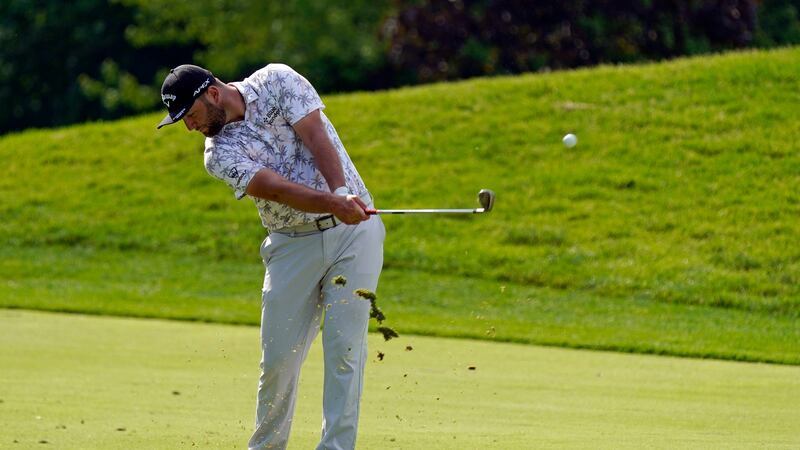 Jon Rahm hits to the 13th green during the third round of the Memorial golf tournament,...