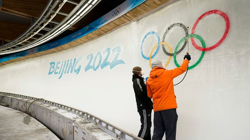 Two ice makers spray water after installing a sub-glacial Beijing 2022 logo on the track at...