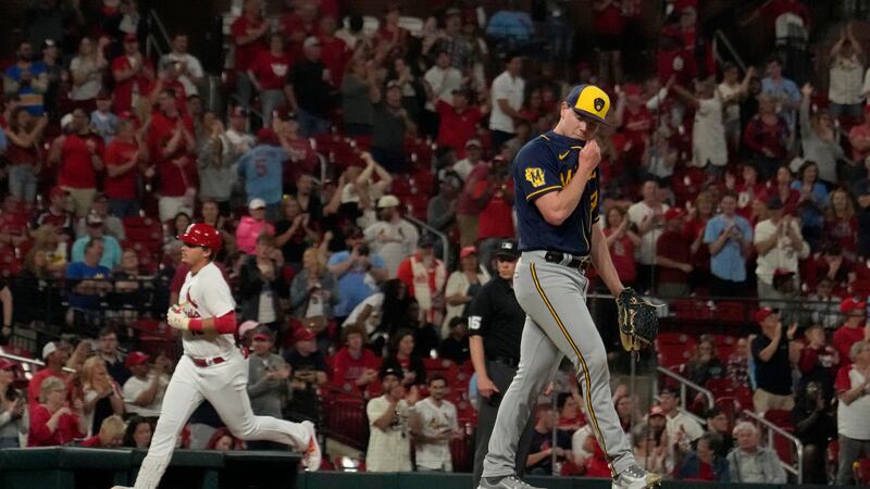 St. Louis Cardinals' Nolan Gorman, left, rounds the bases after hitting a three-run home run...