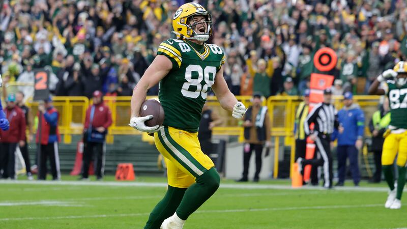 Green Bay Packers tight end Luke Musgrave (88) celebrates after scoring a 20-yard touchdown...