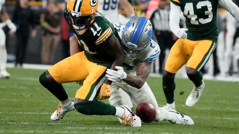 Green Bay Packers wide receiver Jayden Reed (11) fumbles a punt in front of Detroit Lions...