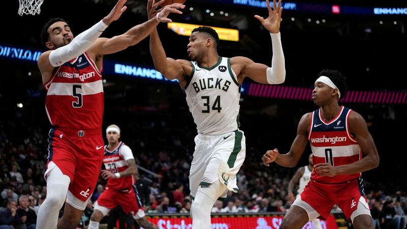Milwaukee Bucks forward Giannis Antetokounmpo (34) and Washington Wizards guards Tyus Jones,...