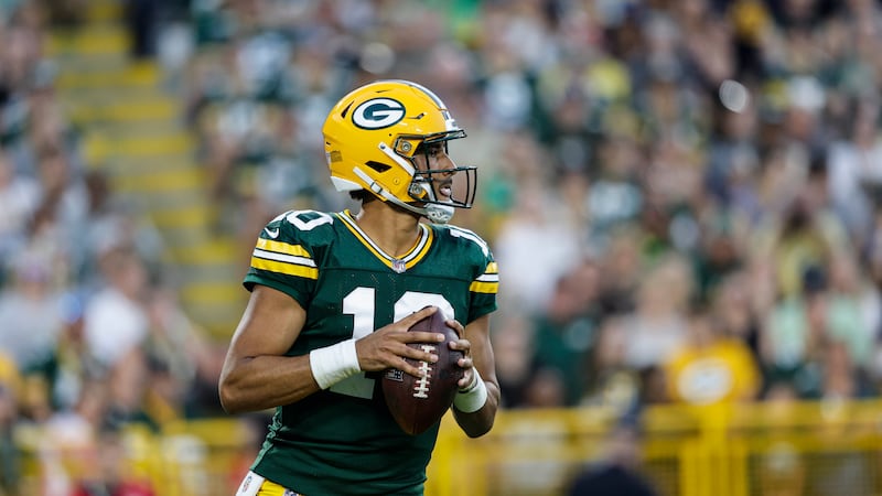 Green Bay Packers quarterback Jordan Love (10) rolls out against the New England Patriots...