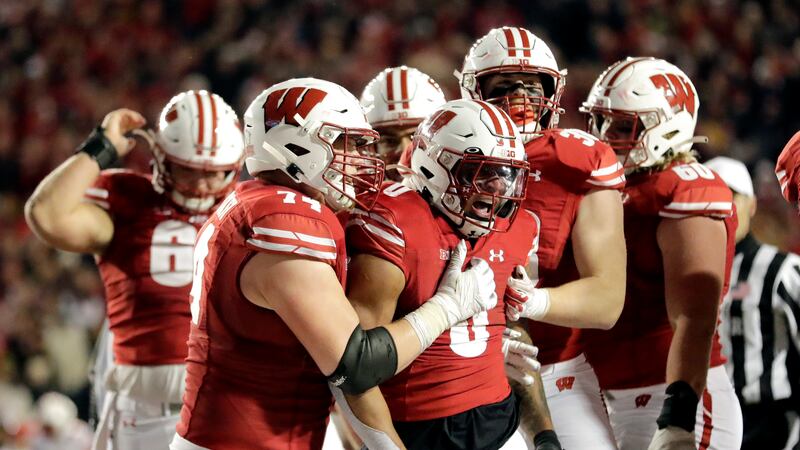 Wisconsin's Braelon Allen is congratulated by teammates during overtime of an NCAA college...
