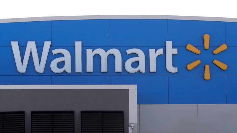 FILE - A Walmart logo is displayed outside of a Walmart store, in Walpole, Mass, Sept. 3,...