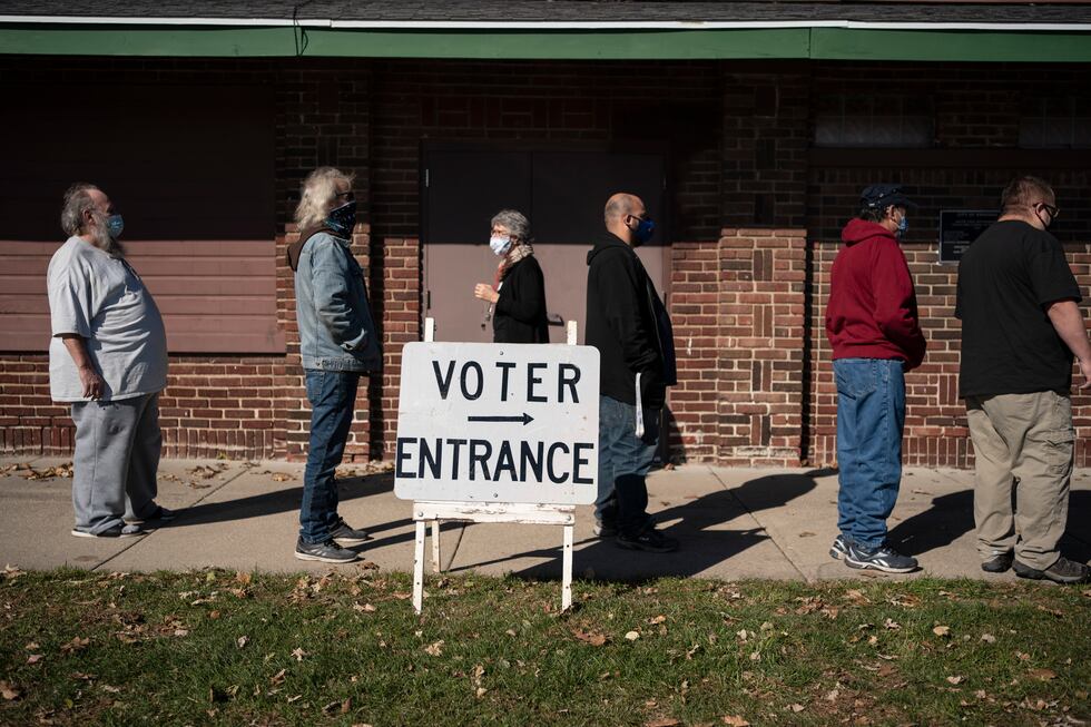 FILE - In this Nov. 3, 2020, file photo, voters wait in line outside a polling center on...