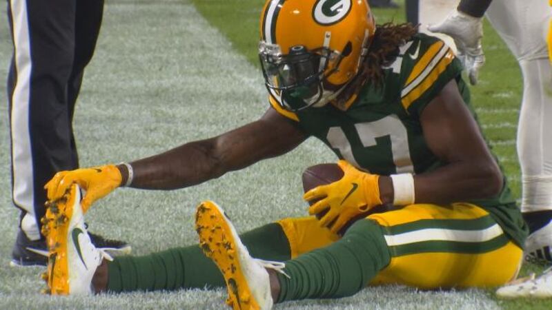 Packers WR Davante Adams grabs his right foot during Thursday's game against the Philadelphia...