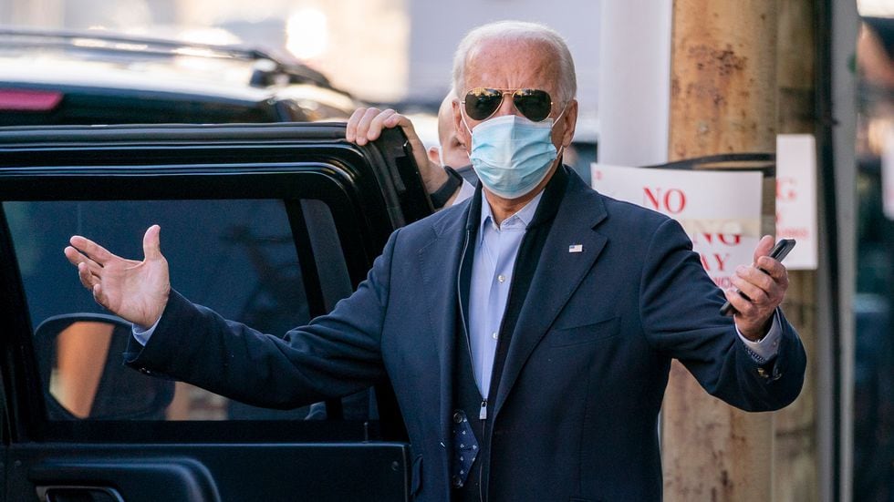 President-elect Joe Biden speaks to reporters as he leaves The Queen theater, Wednesday, Nov....